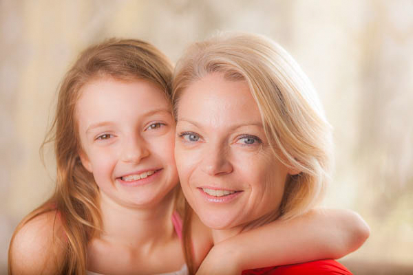 smiling mother and daughter embrace